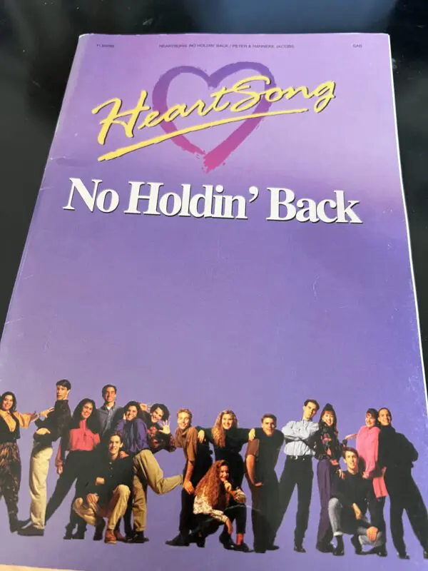 A book cover with the words " heartsong no holdin back ".